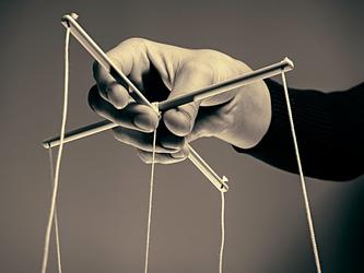 Person playing with puppet strings